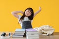 A lovely young Asian girl is stretching her arms, feeling tired after doing homework Royalty Free Stock Photo