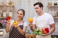 Lovely young caucasian couple in kitchen together Man and woman have fun to prepare ingredient for cooking. Boyfriend and girlfrie