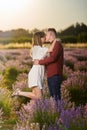 Young couple in a lavender field at sunset Royalty Free Stock Photo