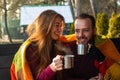 Young happy couple drinking tea   while resting in autumn forest Royalty Free Stock Photo