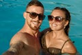 Beautiful woman enjoying hot summer day at poolside