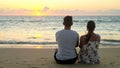 Lovely young couple sits on ocean beach Royalty Free Stock Photo