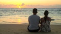 Lovely young couple sits on ocean beach Royalty Free Stock Photo