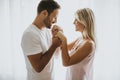 Lovely young couple standing by the window Royalty Free Stock Photo