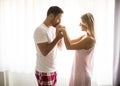 Lovely young couple standing by the window Royalty Free Stock Photo