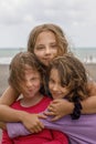 Lovely young girls hugging outdoor. Child girl friends 7, 8 and 10 years old, face closeup portrait Royalty Free Stock Photo