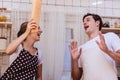 Lovely young happy caucasian couple or lover playful fight in kitchen together. Funny boyfriend and girlfriend have fun in kitchen Royalty Free Stock Photo