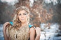 Lovely young lady in elegant dress posing winter scenery, royal look