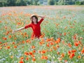 Lovely young romantic woman in straw hat on poppy flower field posing on background summer. Wearing straw hat. Soft Royalty Free Stock Photo