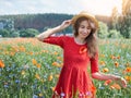 Lovely young romantic woman in straw hat on poppy flower field posing on background summer. Wearing straw hat. Soft Royalty Free Stock Photo