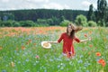 Lovely young romantic woman in straw hat on poppy flower field posing on background summer. Wearing straw hat. Soft Royalty Free Stock Photo