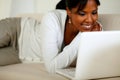 Lovely young woman smiling and looking to laptop Royalty Free Stock Photo