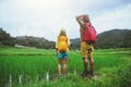 Lover asian men asian women travel nature Travel relax Walking a photo on the rice field in rainy season in Chiang Mai, Thailand Royalty Free Stock Photo