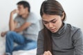 Lover couple relationship problems. Sad young wife sitting on the bed back to back from husband after argument Royalty Free Stock Photo