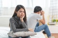 Lover couple relationship problems. Sad young wife sitting on the bed back to back from husband after argument Royalty Free Stock Photo