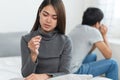 Lover couple relationship problems. Sad young wife sitting on the bed back to back from husband after argument and thinking. Royalty Free Stock Photo