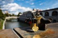 Lover padlocks locked to figurine on bridge over the Ljubljanica river in Ljubljana on sunny day