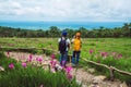 Lover woman and men Asian travel nature. Travel relax. Photography Cucumber sessilis flower field Royalty Free Stock Photo