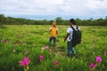 Lover woman and men Asian travel nature. Travel relax. Photography Cucumber sessilis flower field Royalty Free Stock Photo