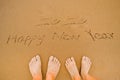 Lover Write 2020 happy new year on beach