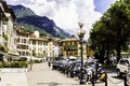 LOVERE, ITALY, June 30, 2017: Cozy street with houses, parked motorcycles against the background of beautiful mountains and