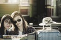 Lovers of Asian women lesbian LGBT couples,View map on old bench In platform of train station, concept of travel holiday pleasure Royalty Free Stock Photo