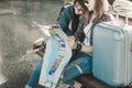 Lovers of Asian women lesbian LGBT couples,View map on old bench In platform of train station, concept of travel holiday pleasure Royalty Free Stock Photo