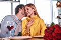 Lovers at beginning of love story - Handsome man whispers in pretty woman ear Royalty Free Stock Photo