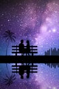 Lovers on bench in park. Loving couple silhouette. Milky Way at night Royalty Free Stock Photo