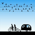 Lovers on bike tandem under birds on wires