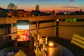 Lovers celebrate romantic dinner on the terrace with the light of the candle and wine on the confined of the quarantine.