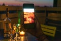 Lovers celebrate romantic dinner on the terrace with the light of the candle and wine on the confined of the quarantine.