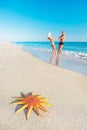 Lovers couple at sandy sea beach with red starfish Royalty Free Stock Photo