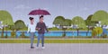 Lovers couple under umbrella man woman romantic walking in rain city urban park landscape background full length Royalty Free Stock Photo