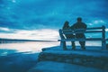 Lovers drink wine on the beach at sunset