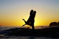 Lovers embrace silhouetted by a sunset Royalty Free Stock Photo