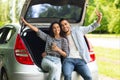 Lovers embracing and cheerfully smiling at camera, raising hands up Royalty Free Stock Photo