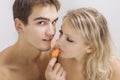 Lovers enjoying fruit breakfast in bed Royalty Free Stock Photo