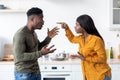 Lovers Fight. Portrait Of Andry Black Couple Emotionally Arguing In Kitchen Royalty Free Stock Photo