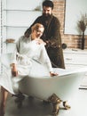 Lovers are fooling around. Everyday life. Morning hygiene. Relaxing time. Young adult body care morning routine. Morning