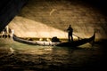 Lovers in Gondola under a Bridge in Venice Royalty Free Stock Photo