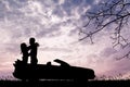 Lovers kissing on car