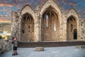 Lovers kissing at Romanic basilica ruins, old town Rhodes, Greece