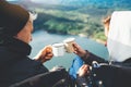 Lovers looking at each other, couple enjoy together of sun flare mountain, travelers drink tea on cup enjoy nature, romantic look Royalty Free Stock Photo