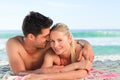 Lovers lying down on the beach Royalty Free Stock Photo