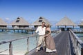 Lovers, man and woman on a wooden path at the sea, tropics Royalty Free Stock Photo