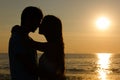 Lovers silhouette passionately close to each other at sunset