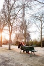 Lovers sit on a bench near Eiffel tower in Paris. travel at spring in France Royalty Free Stock Photo