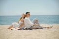 Lovers siting looking into sky and ocean, mountion, under sun. Vacation, tourism, hooneymoon. Girl with a long hair Royalty Free Stock Photo