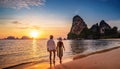 lovers walking on the beach with sunset Royalty Free Stock Photo